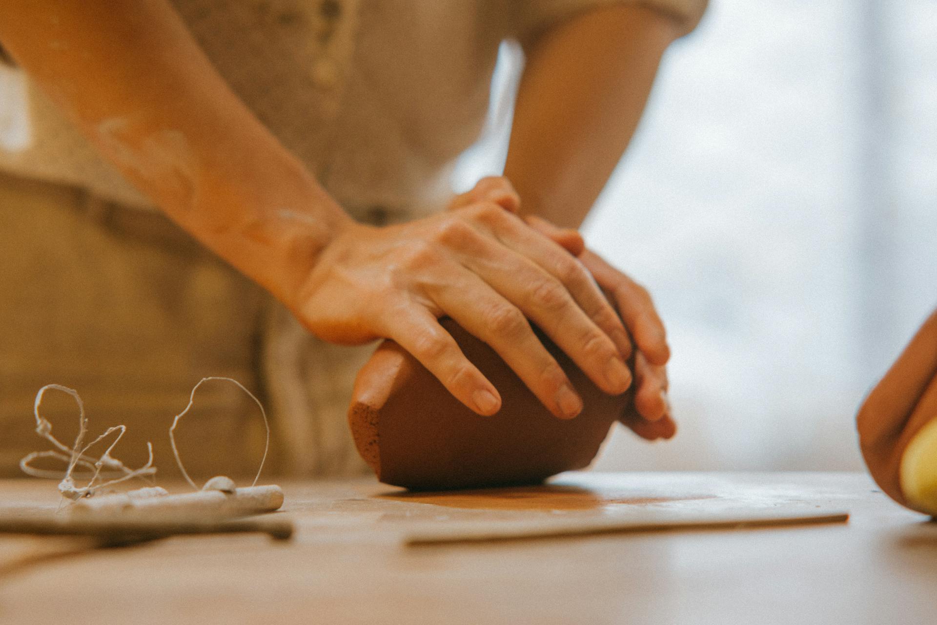 Person kneading clay at Dartmoor Makers community pottery studio